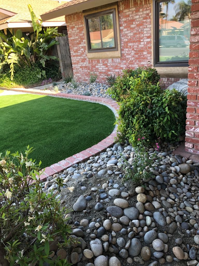 Front yard lawn with river rock accent planters